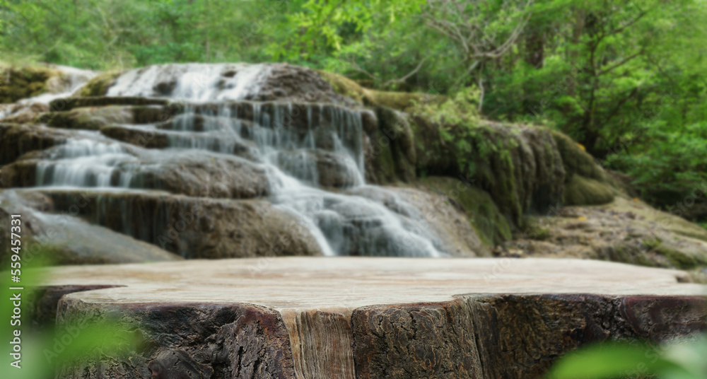 wood table top podium in outdoors waterfall green lush tropical forest nature background.organic healthy natural product present placement pedestal counter display,website banner cover jungle concept.