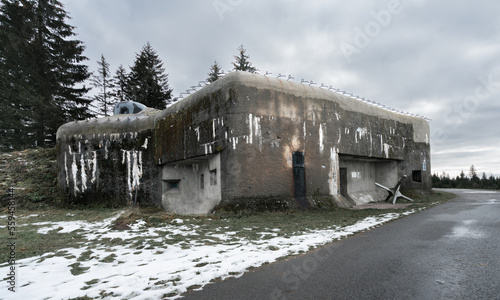Old concrete infantry blockhouse Na Holem in Bartosovice, Czech Republic, on a gloomy cloudy day of winter. Military fortress building on a cold gloomy winter day without snow. photo