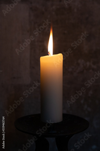 One burning candle, a symbol in the church