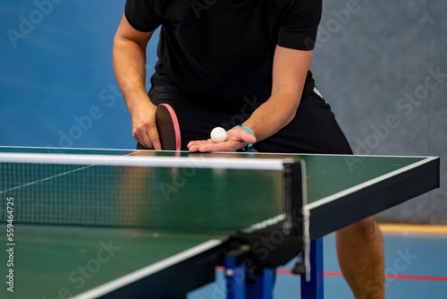 Table Tennis Player serving, holding ball in hand © DWP