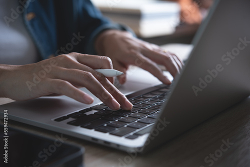 Business woman online working, females hands typing on laptop computer and using digital tablet on office table at home, Student studing online, close up, E-learning concept