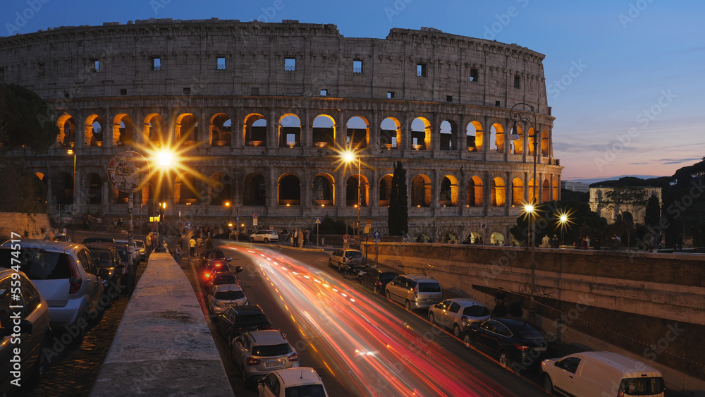 ROME, ITALY - OCTOBER 06, 2018: Sunset dusk street city lights fast motion timelapse at Colosseum in Rome