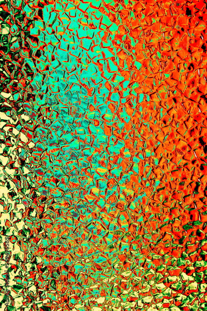 Textured background of corrugated wavy glass. Abstract relief pattern on the glass surface. Colorful embossed pattern, background. Changed color scheme. Textured background of corrugated wavy glass. Abstract relief pattern on the glass surface. Colorful embossed pattern, background. Changed color scheme.