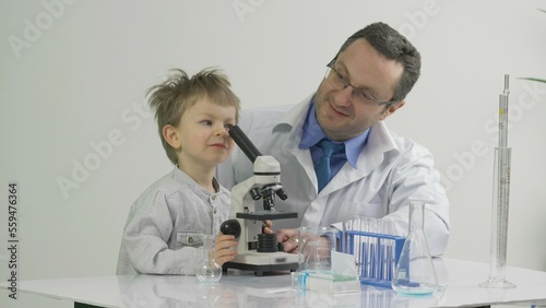 Father and son using a microscope in the laboratory