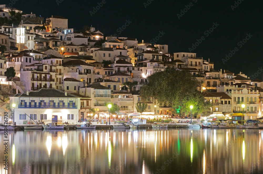 Skopelos harbor night lights mirrored in the Mediterranean Sea