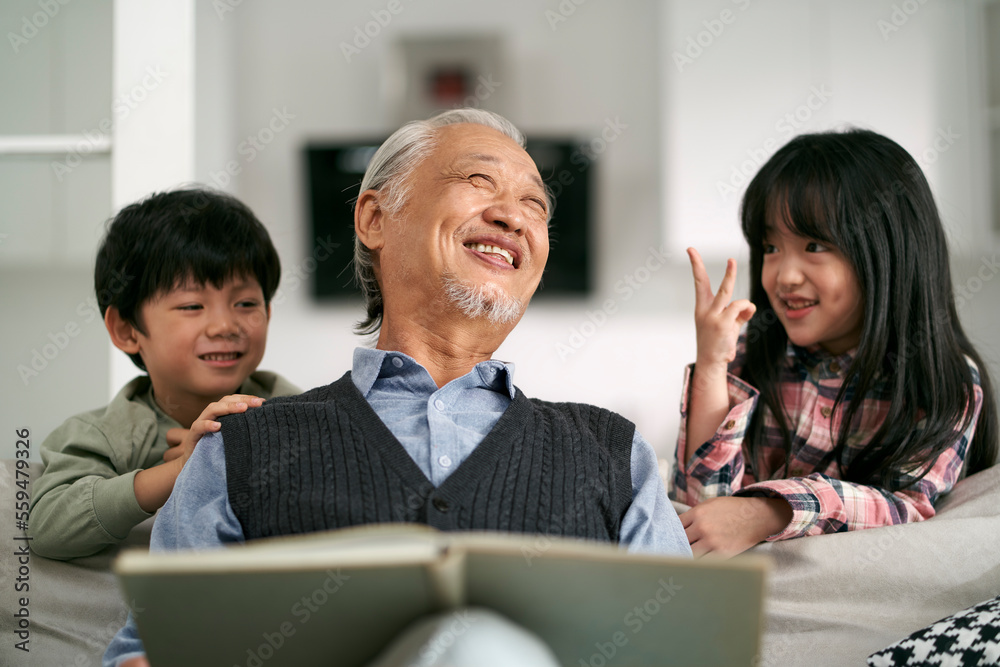 asian grandpa and two grandchildren having a good time at home asian grandpa and two grandchildren having a good time at home