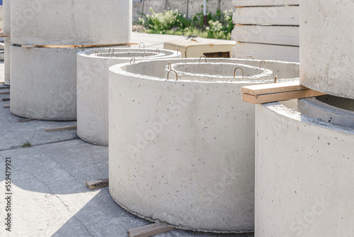 Reinforced concrete rings of different diameters for the construction of an autonomous sewer, septic tank, well. Warehouse for finished products of the precast concrete plant.