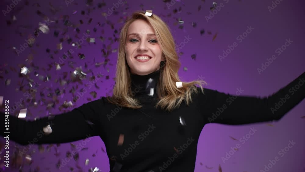Portrait of young, caucasian lady enjoying holiday decorations. Close-up shot of blonde-haired, attractive woman throwing golden confetti. High quality 4k footage Portrait of young, caucasian lady enjoying holiday decorations. Close-up shot of blonde-haired, attractive woman throwing golden confetti. High quality 4k footage