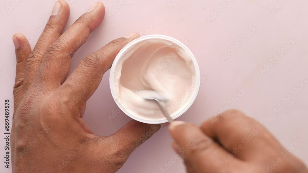 spoon pick fresh yogurt in a plastic container spoon pick fresh yogurt in a plastic container
