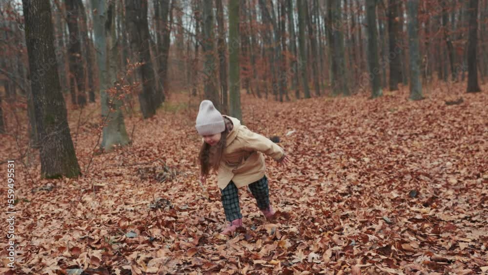 A girl of 4 years old runs through the autumn forest A girl of 4 years old runs through the autumn forest