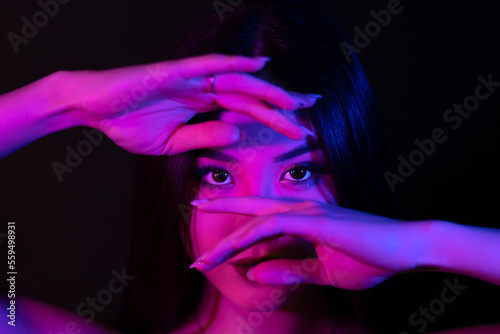 Canvastavla Young asian woman portrait in red-blue neon lights.