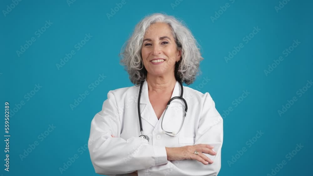 Friendly doctor posing with a lab coat and a stethoscope Friendly doctor posing with a lab coat and a stethoscope