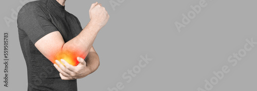 Photography man with elbow pain on gray background