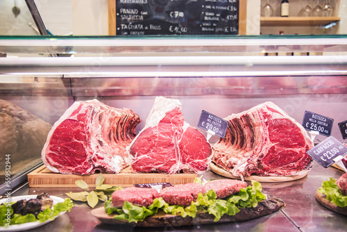 Fiorentine beef steak - Butcher's shop selling raw meat at traditional italian market stall  photo