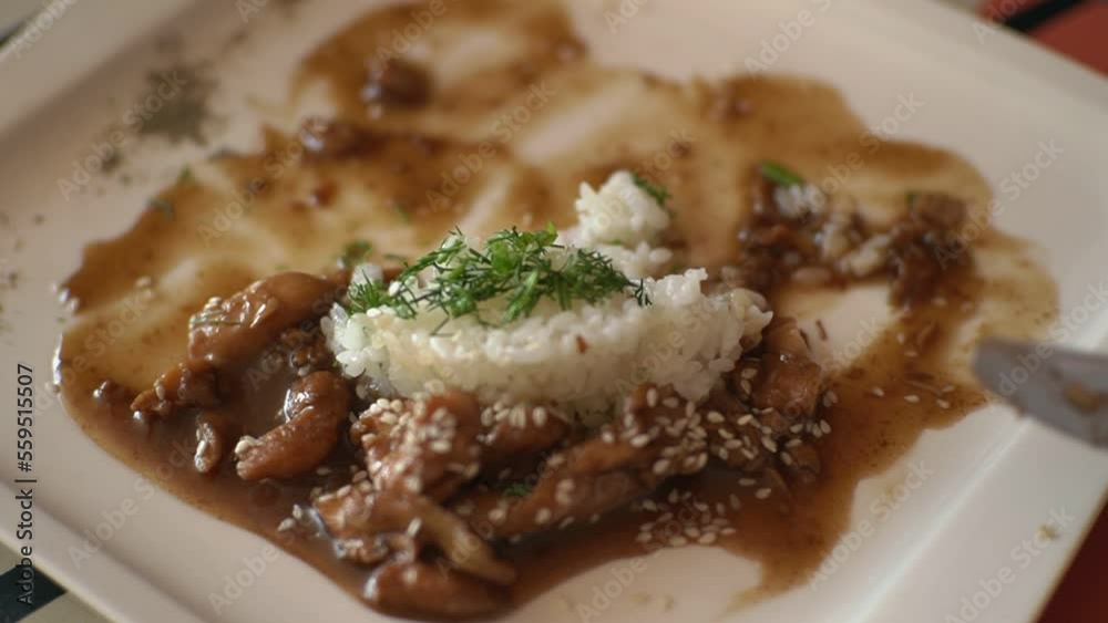 a man with a fork eats rice with meat. High-quality FullHD video recording. real-time video a man with a fork eats rice with meat. High-quality FullHD video recording. real-time video