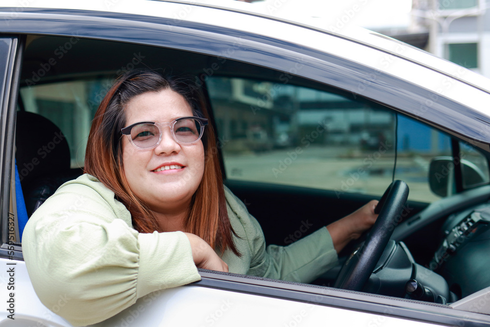 Asian fat woman wearing vintage glasses Are driving a car to travel. Travel concept. Transportation Travel by private car. Outdoor adventure travel. car insurance