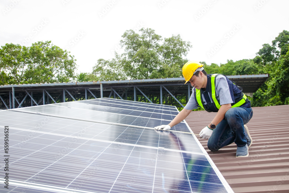 Asian technicians install panels Solar cells to produce and distribute electricity. Energy technology concept. copy space Asian technicians install panels Solar cells to produce and distribute electricity. Energy technology concept. copy space