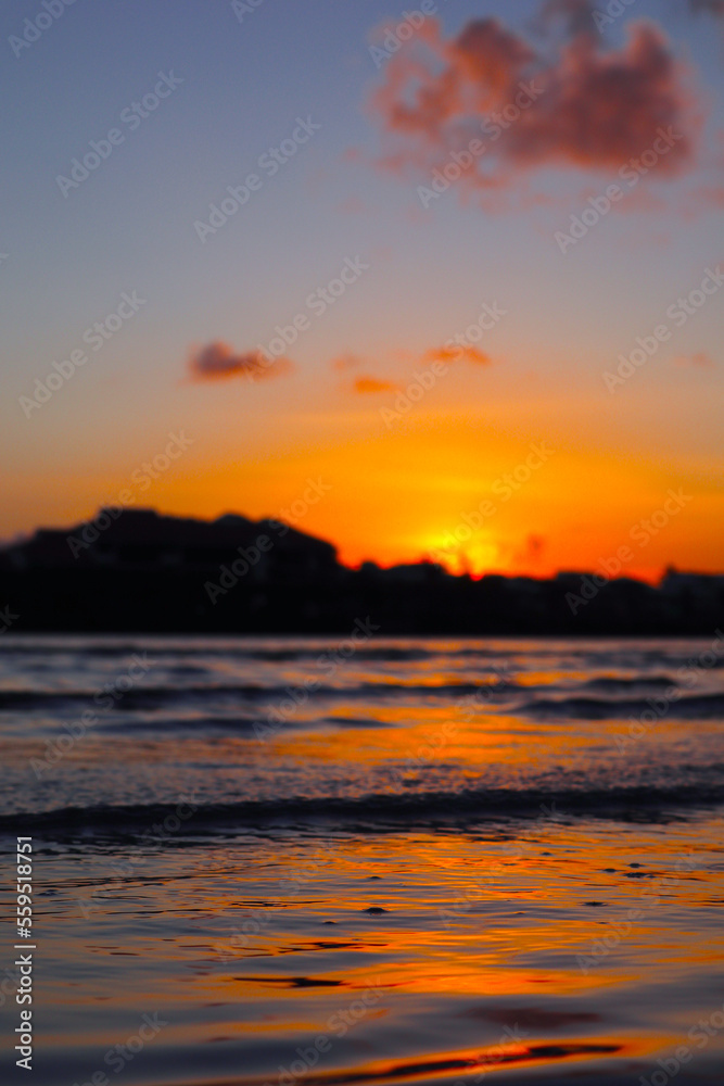 sunset over the sea orange pink red skies reflection of sunset in the water 