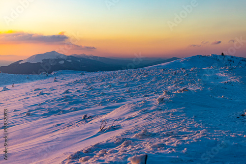 Fototapeta Naklejka Na Ścianę i Meble -  panorama of snowy mountains bieszczady at sunset, coniferous trees covered with snow, colorful winter sunset seen from the top of the mountain bukowe berdo