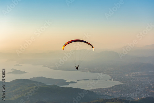 Paragliding from Babadag Mountain at Sunset overlooking Oludeniz near Fethiye in Turkey