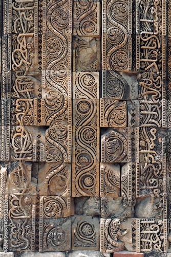 Floral Motfis decoration in the wall of Qutb Minar complex at New Delhi, India. Relief carving at the old monument. Unesco heritage site at Delhi.