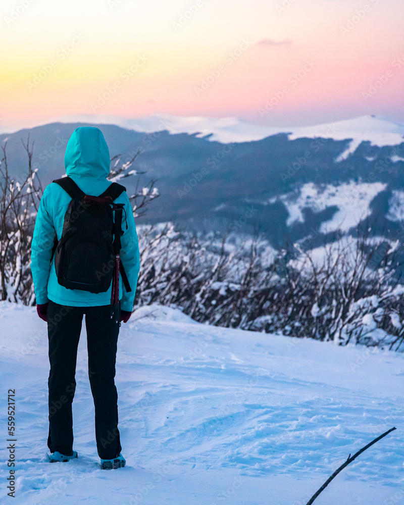 backpacker girl walks along the top of snowy mountains bieszczady at sunset, winter sunset seen from the top of the mountain wielka rawka backpacker girl walks along the top of snowy mountains bieszczady at sunset, winter sunset seen from the top of the mountain wielka rawka