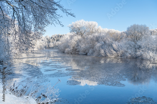 Reflections of snow covered trees in the River Teviot, Scottish Borders, United Kingdom © dvlcom