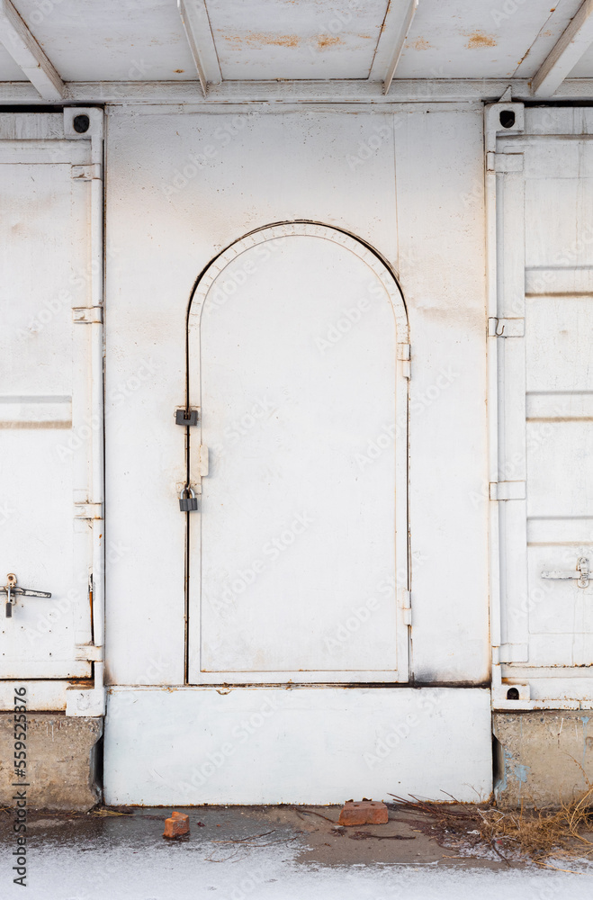 old metal door of white color with traces of rust