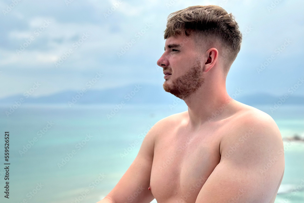 handsome and sporty, topless guy enjoying and sunbathing in the sun on the rooftop of a lux hotel spa suite with sea,ocean view on vacation handsome and sporty, topless guy enjoying and sunbathing in the sun on the rooftop of a lux hotel spa suite with sea,ocean view on vacation