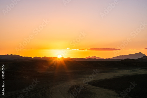 sunset over the mountains in the middle of the african desert © Dave Marzotto