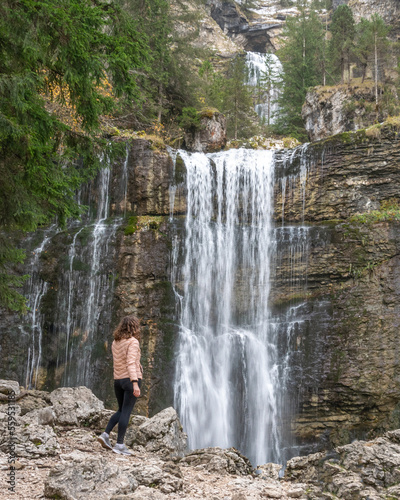 Woman looking a waterfall