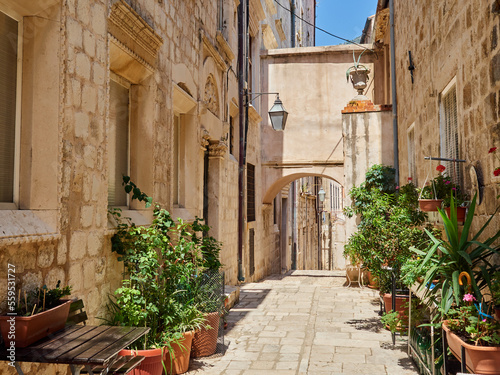 Traditional alley with stone houses and an archway in Dubrovnik Old Town in summer. Croatia, Europe