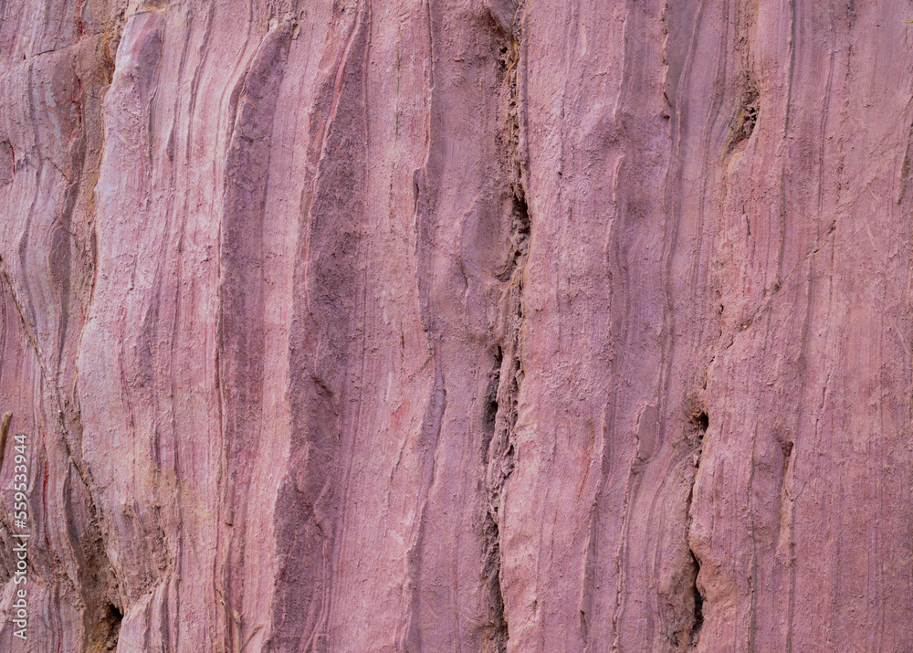 Naklejka premium Closeup of the pink colored rock wall background and texture with detailed