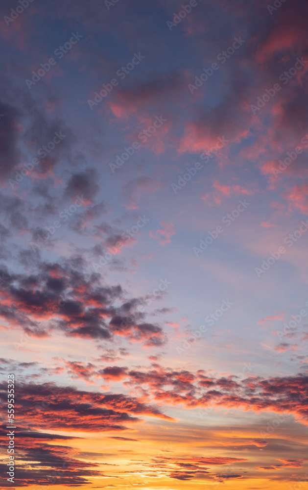 Sunset sky. Yellow sky with purple clouds