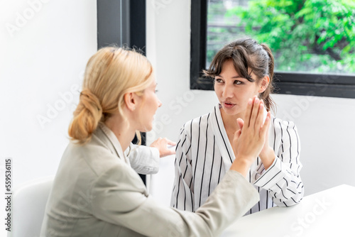 Businesswoman working at the company talking to colleagues, teamwork.