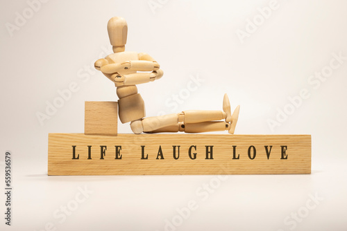 LIFE LAUGH LOVE written on the wooden surface. Wooden Concept
