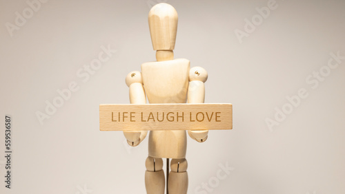 LIFE LAUGH LOVE written on the wooden surface. Wooden Concept