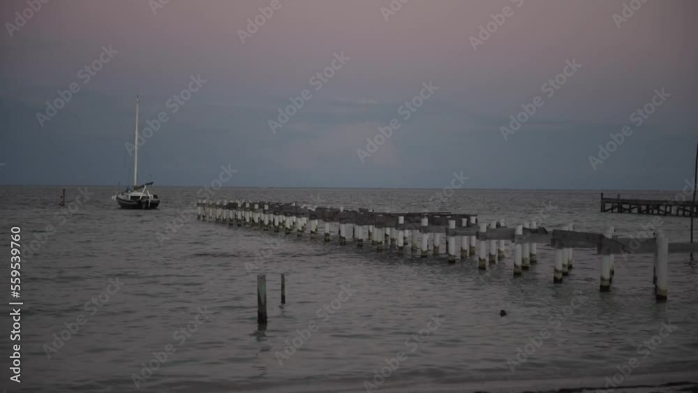Pier and Harbour in Caye Caulker Island in Belize, Caribbean Sea. Cloudy Sky. Windy Pier and Harbour in Caye Caulker Island in Belize, Caribbean Sea. Cloudy Sky. Windy