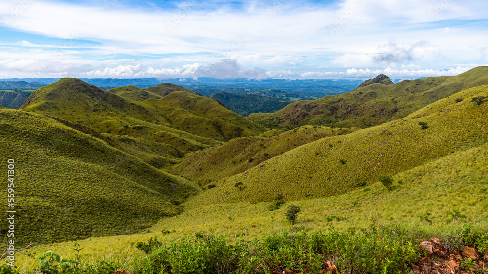 panorama of Costa Rica's cerro pelado mountains during a sunny day; mighty mountains covered with green, succulent grass; mountains in the tropics amidst rainforests