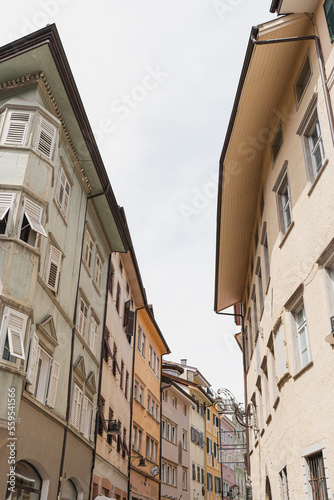 Historic architecture in Italy. Traditional European old town street buildings. Wooden windows  shutters and colourful pastel walls. Aesthetic summer vacation travel background