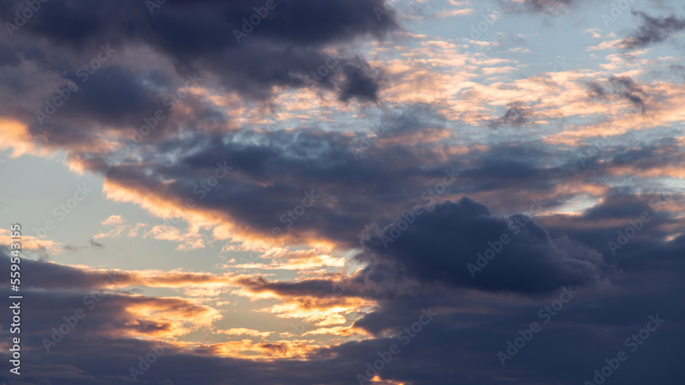 Beautiful orange bright sunset sky with clouds. Sunset sky background.