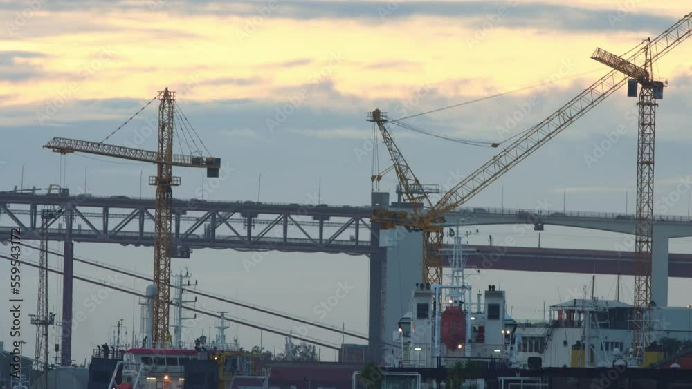 Industrial crane and two-story bridge at early sunset Industrial crane and two-story bridge at early sunset