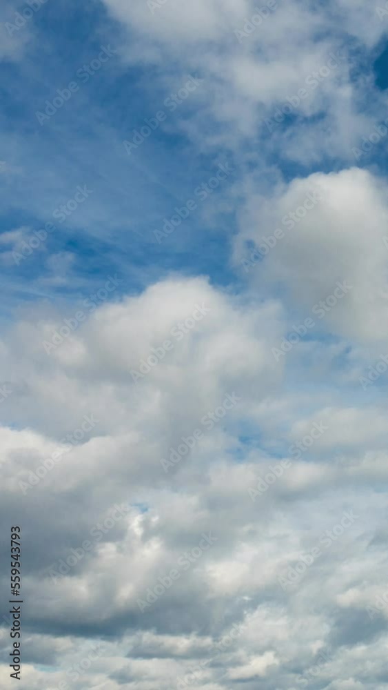 Beautiful vertical time lapse of clouds flying in blue sky Beautiful vertical time lapse of clouds flying in blue sky