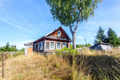Abandoned old rural wooden house in russian village in summer sunny day © Alexandr Blinov