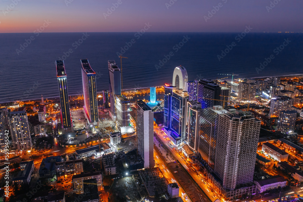Obraz premium Drone aerial view of skyscrapers in night Batumi City, Georgia