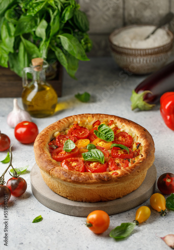 Vegetable yeast pie with tomatoes, red pepper, egg plant and basil on white background. Pie with vegetables 