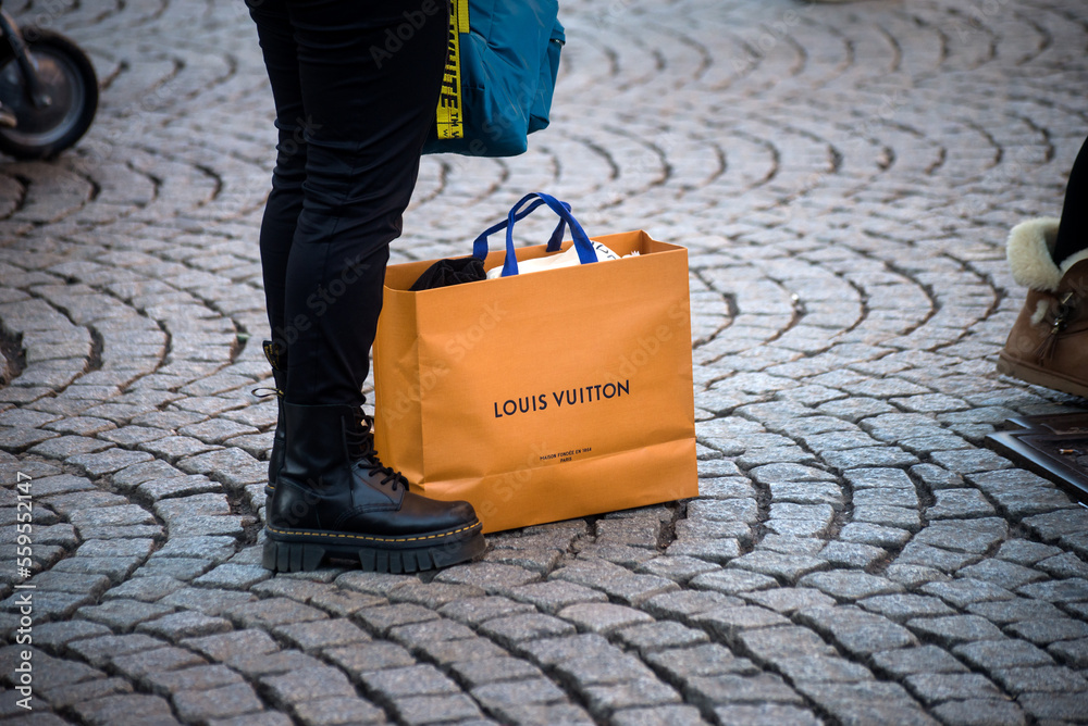 Strasbourg - France - 7 January 2022 - Closeup of woman with a louis  vuitton paper bag in the street foto de Stock
