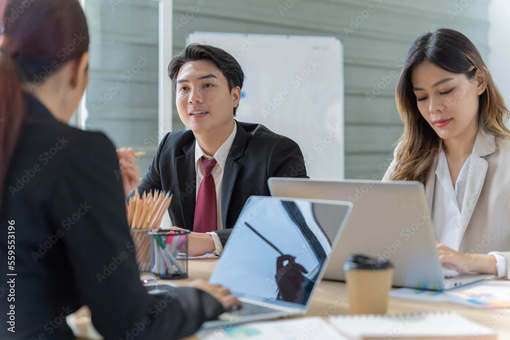 A group of young Asian businessmen Talking and planning work happily and have fun. at the company's office