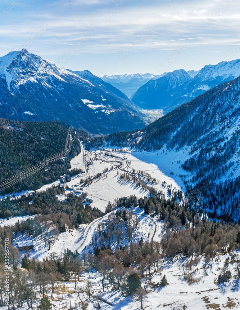 Aerial view of the Poschiavo valley viewed from Alp Gruem on the Bernina pass in winter, Switzerland