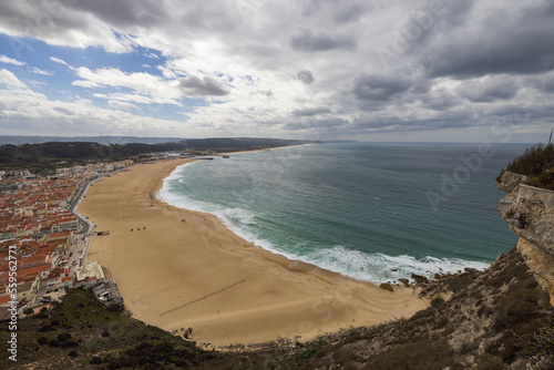 High angle view of the south beach of Nazaré, Portugal with the harbor and ocean